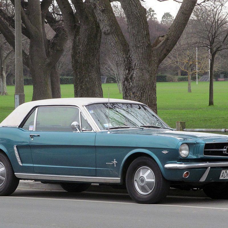 1965 Ford Mustang parked on the side of a road in Christchurch.