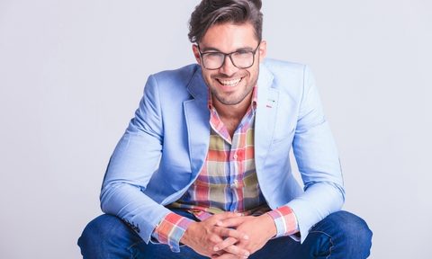 Man in light blue sport coat kneeling