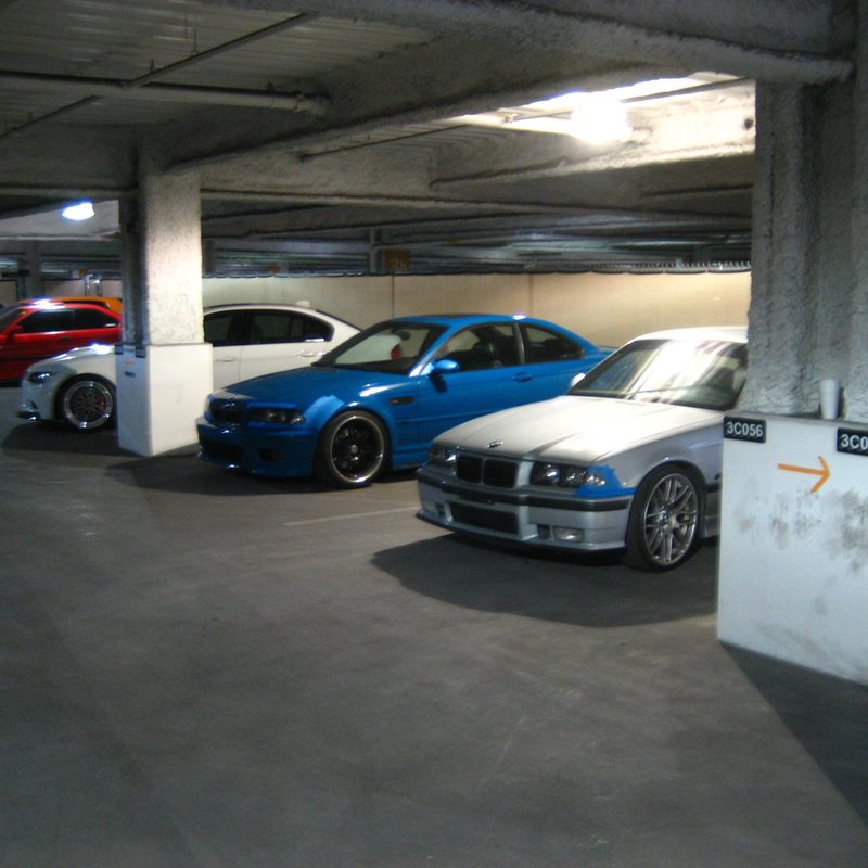 Colorful BMWs in a parking structure