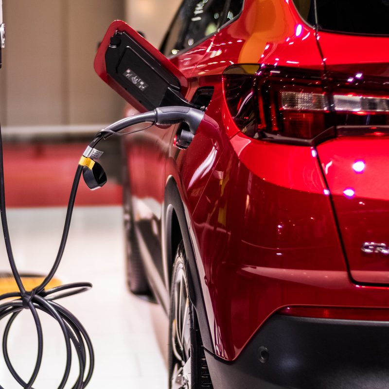 Red electric vehicle plugged in