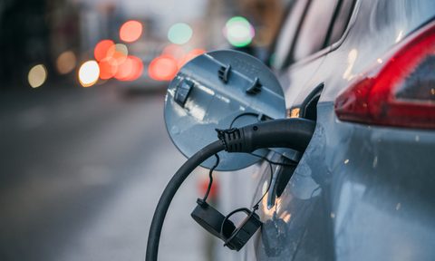Electric car plugged into charger
