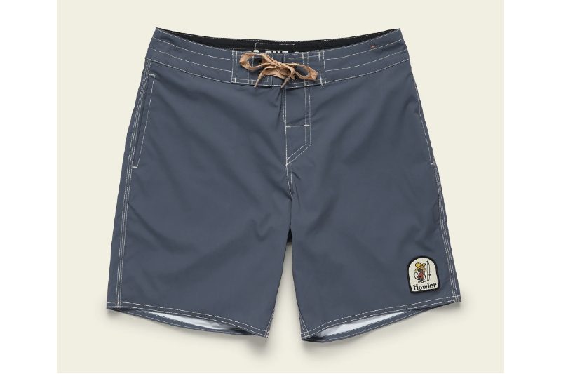 Howler Brothers Buchannon Boardshorts in gray navy on a beige background.