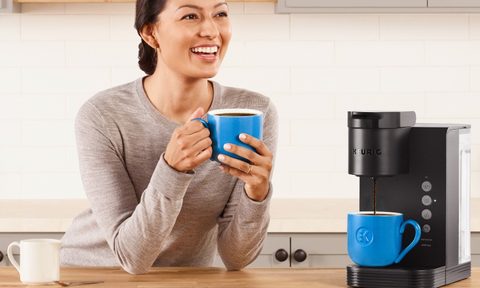Woman drinking coffee from a Keurig