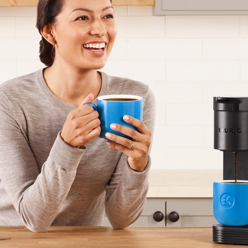 Woman drinking coffee from a Keurig