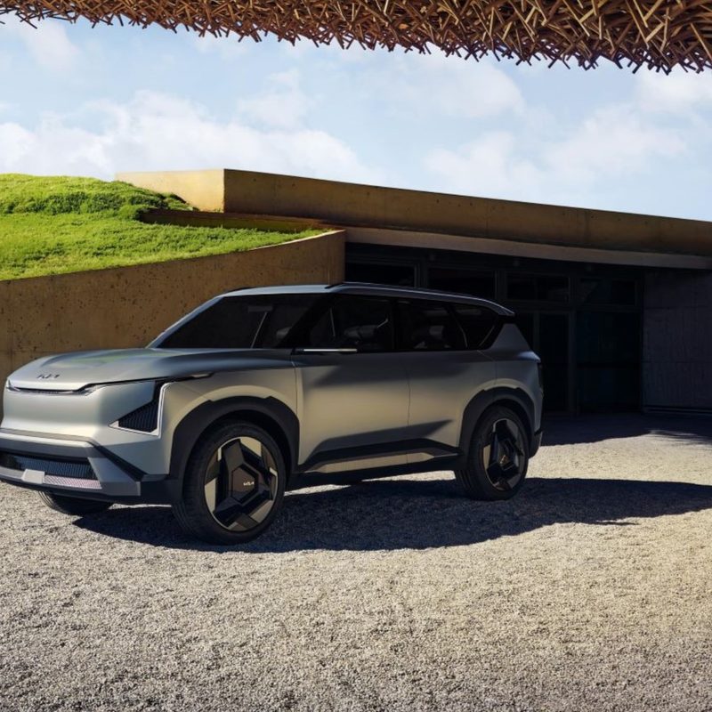 Kia EV5 concept car parked in front of a house
