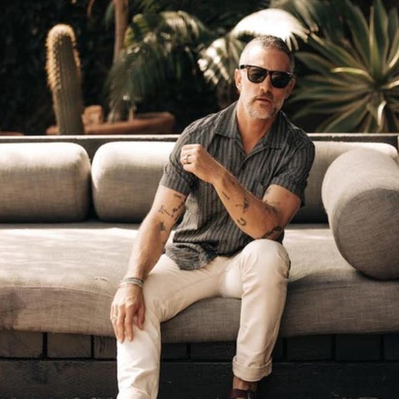 Man on a couch in Taylor Stitch shirt