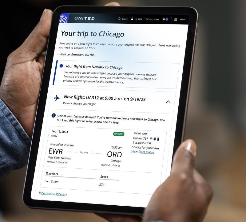 A person on a tablet on the United Airlines app.