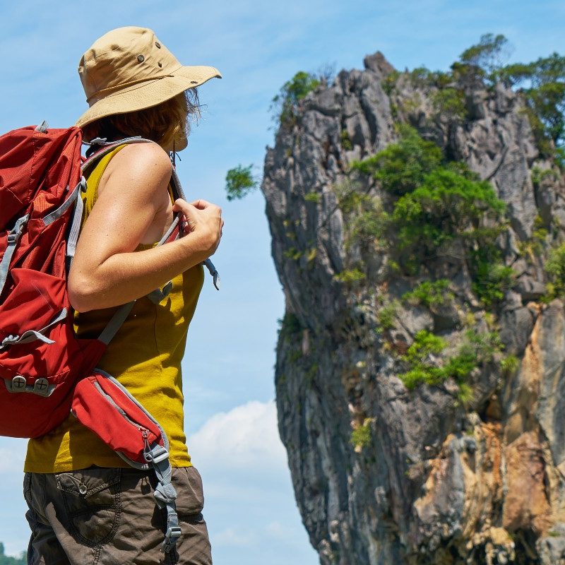 A backpacker with a sun hat on
