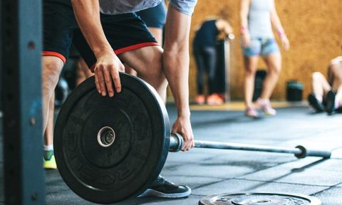 Man loading barbell.