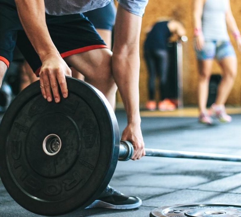 Man loading barbell.