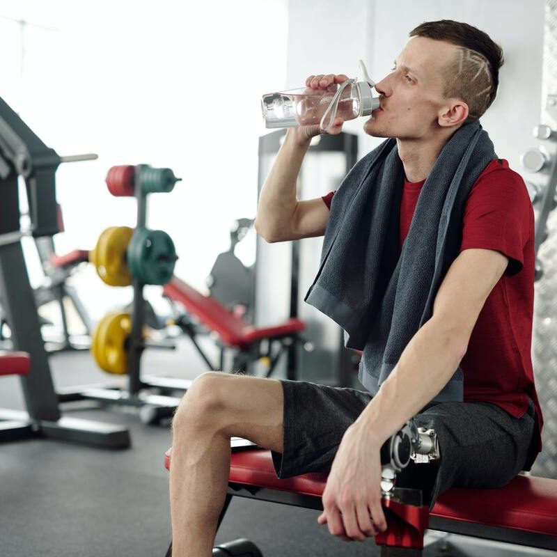 Man with towel and water bottle.