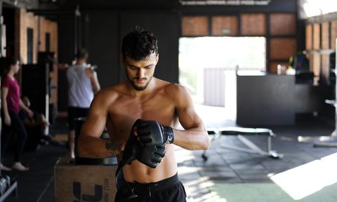 Man putting on boxing gloves