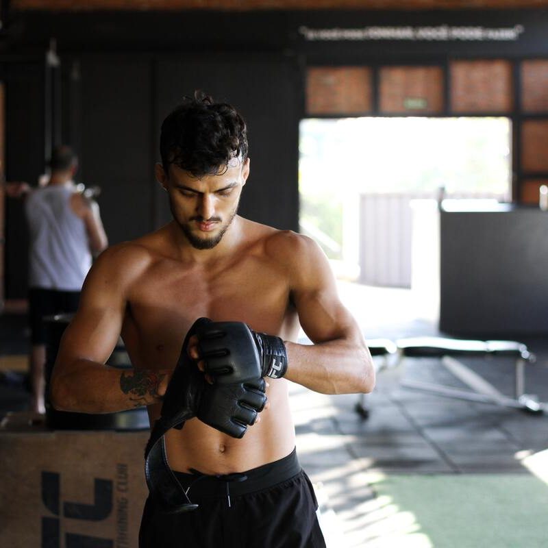 Man putting on boxing gloves