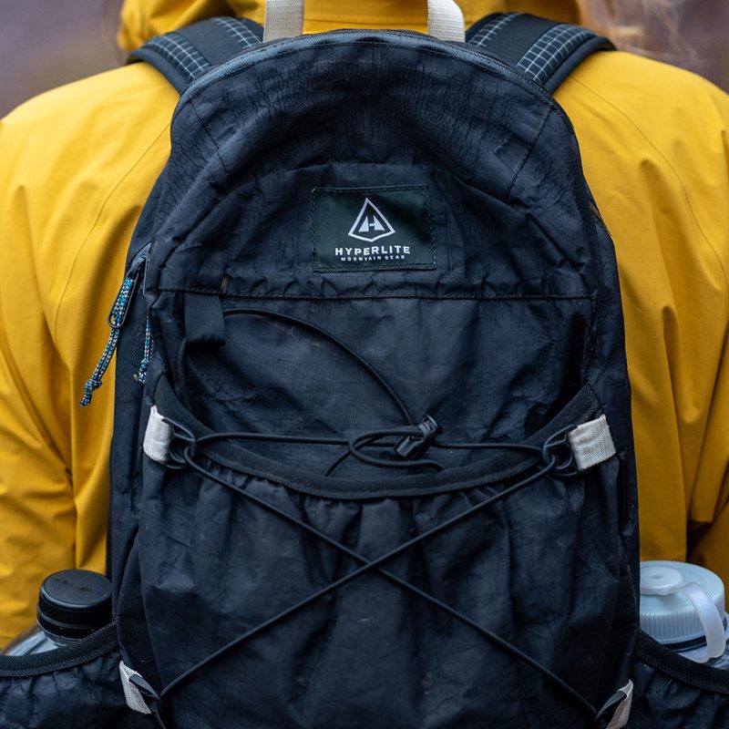 Hiker wearing a Hyperlite Mountain Gear Daybreak Ultralight Daypack in the wild.