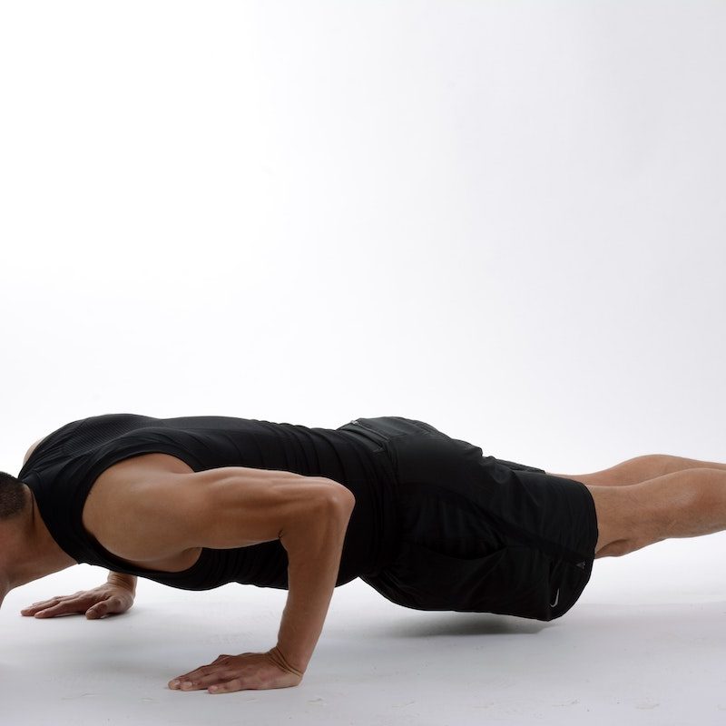 man doing a pushup, white background