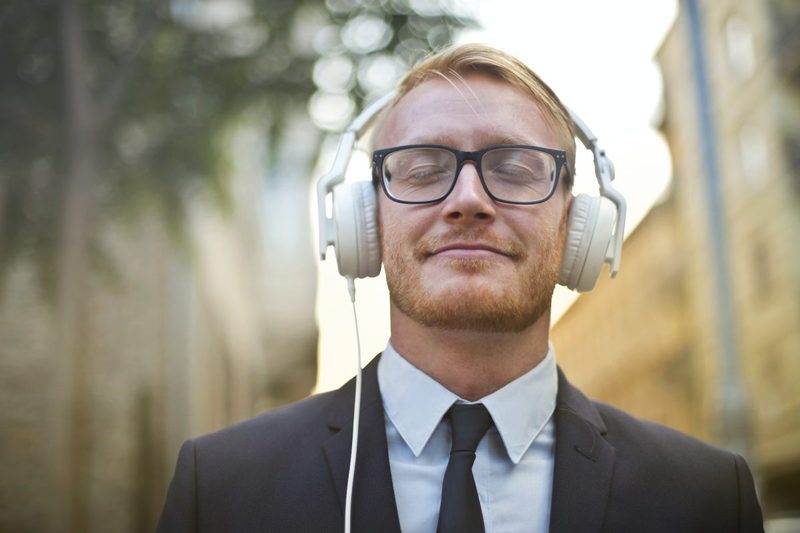 A man wearing headphones and wearing glasses.