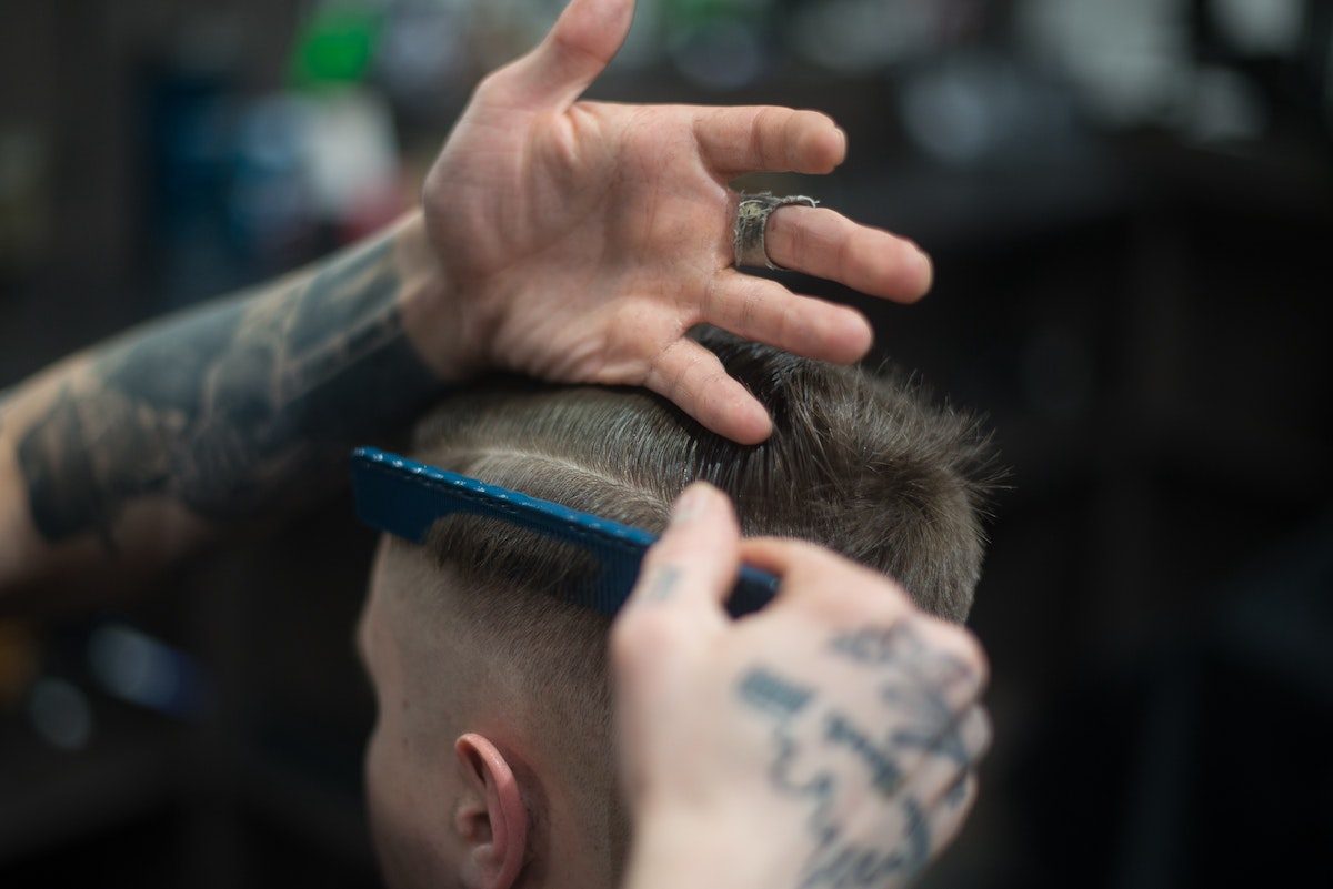 man getting hair combed at barber