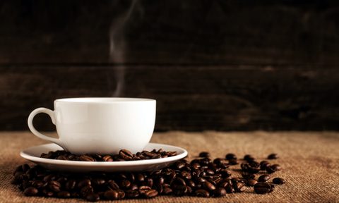 Cup of coffee with beans on a table