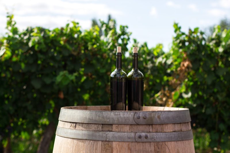 Two wine bottles on barrel