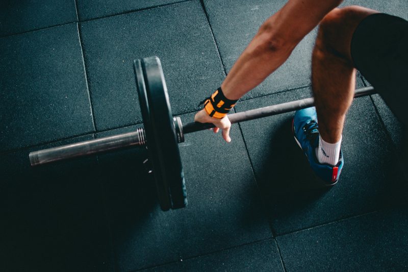 man at the gym lifting a dumbbell