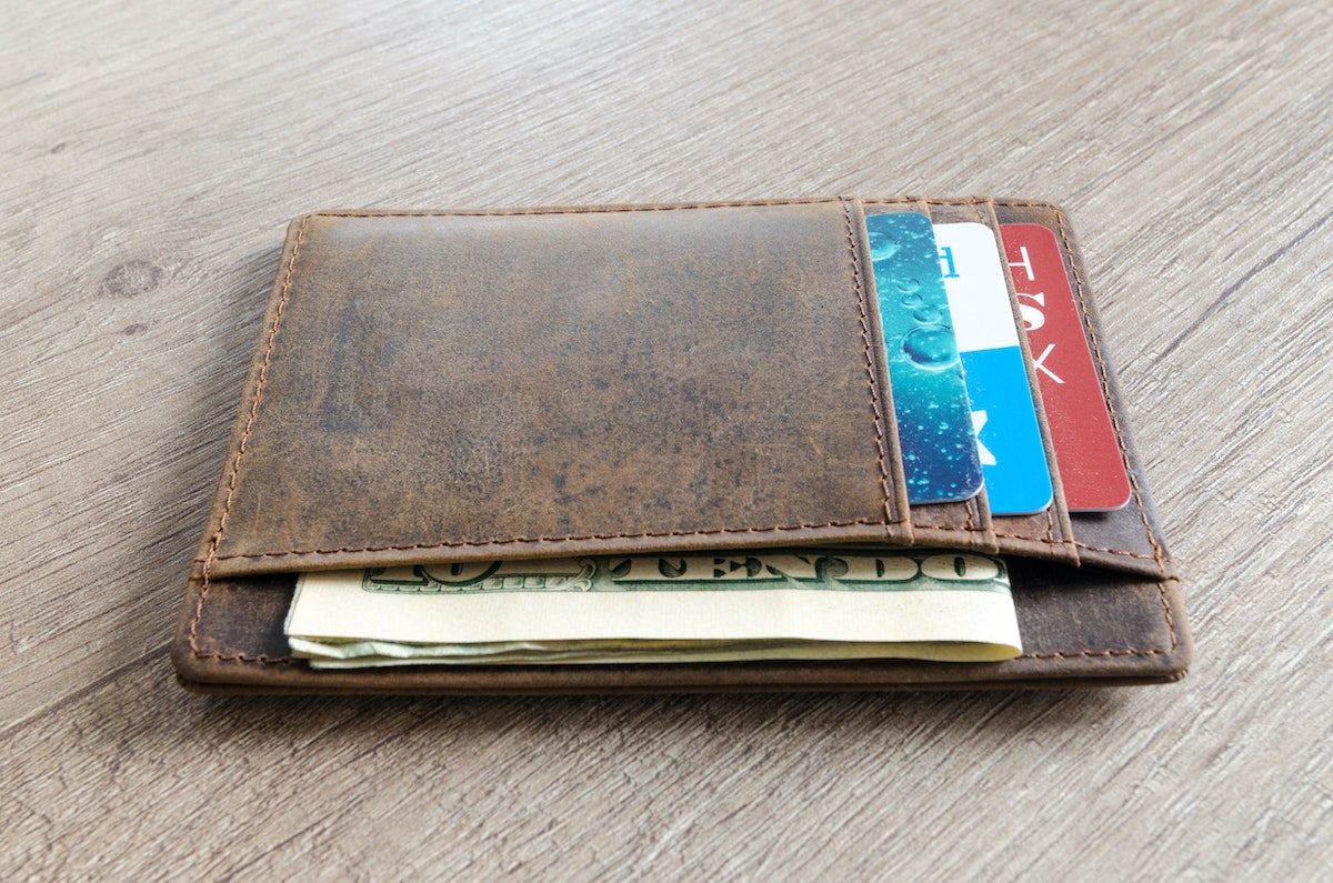 a vintage brown wallet on a wooden table