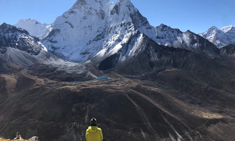 A hiker looks out over Mount Everest.