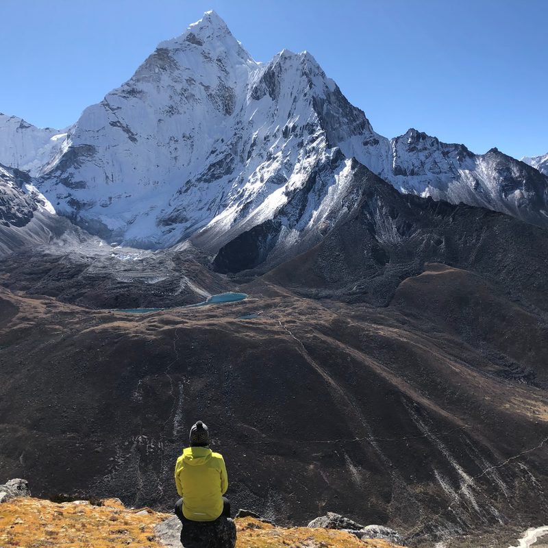A hiker looks out over Mount Everest.