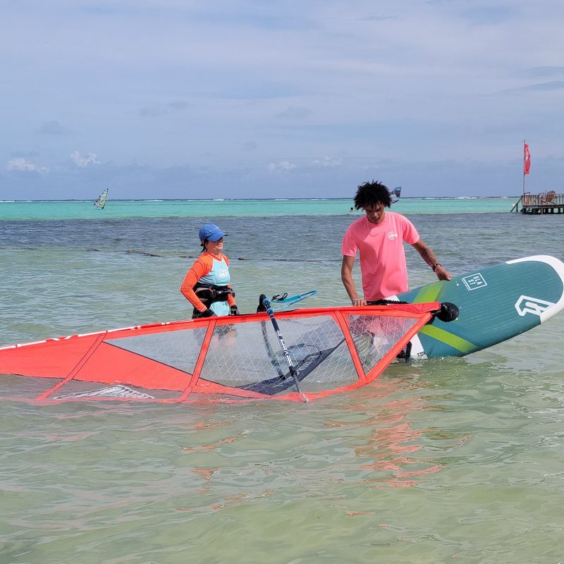 A pair of windsurfers are in the water at Sorobon Beach in Bonaire.