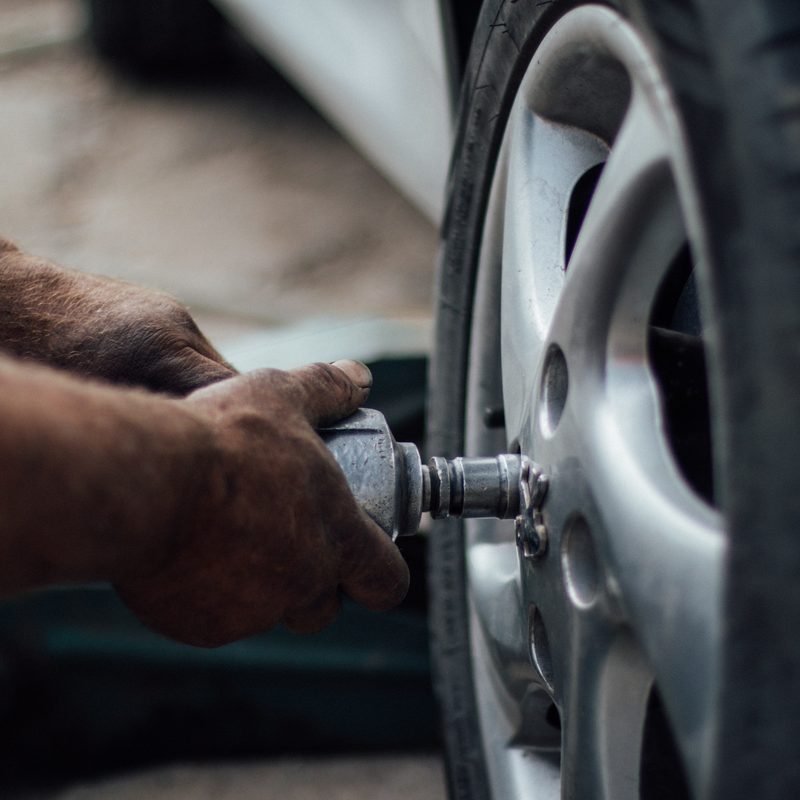 A tie technician changing worn tires.