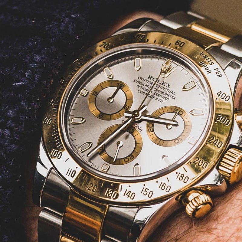 A Rolex Daytona on a wrist