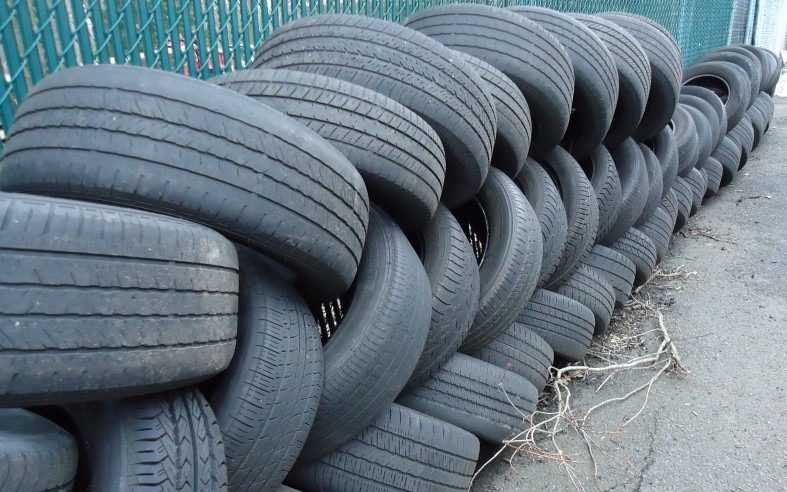 Discarded worn tires at a tire shop.