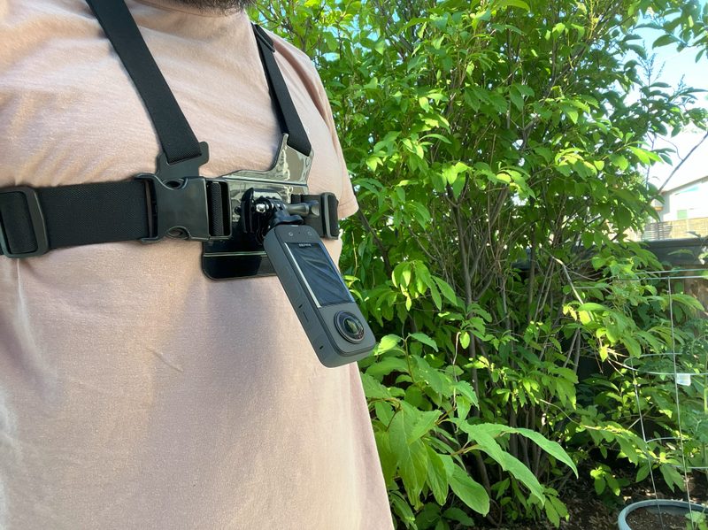 The Insta360 X3 strapped on using a chest mount