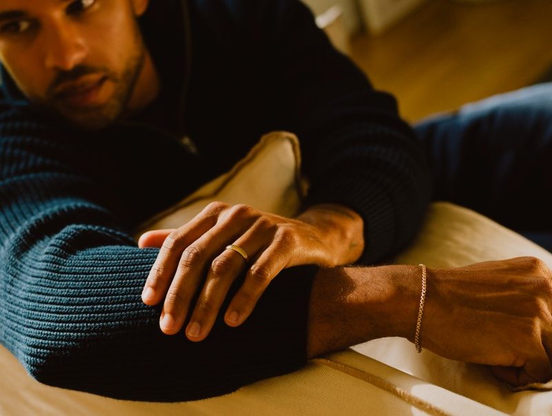 Man in sweater with bracelet and ring