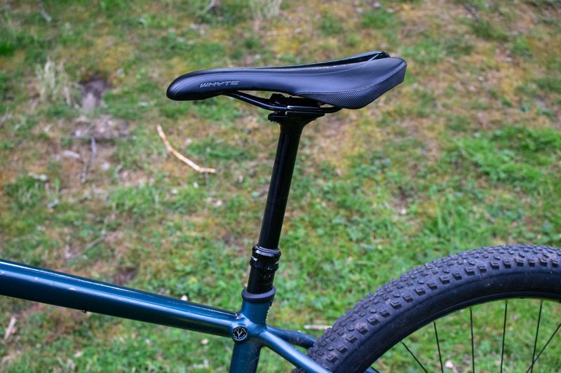 A seat and dropper post of a mountain bike.
