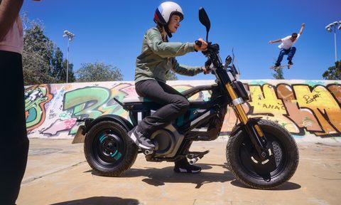 A person riding the BMW CE 02 in what appears to be a skate park