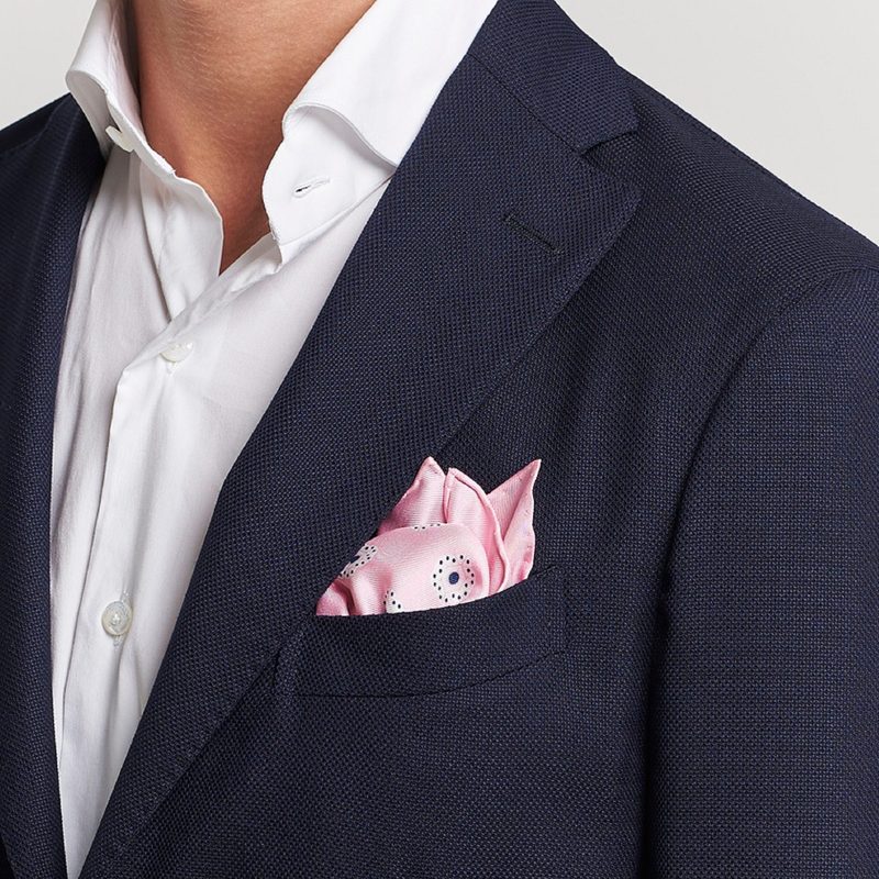 Man with blue blazer and pink pocket square close up