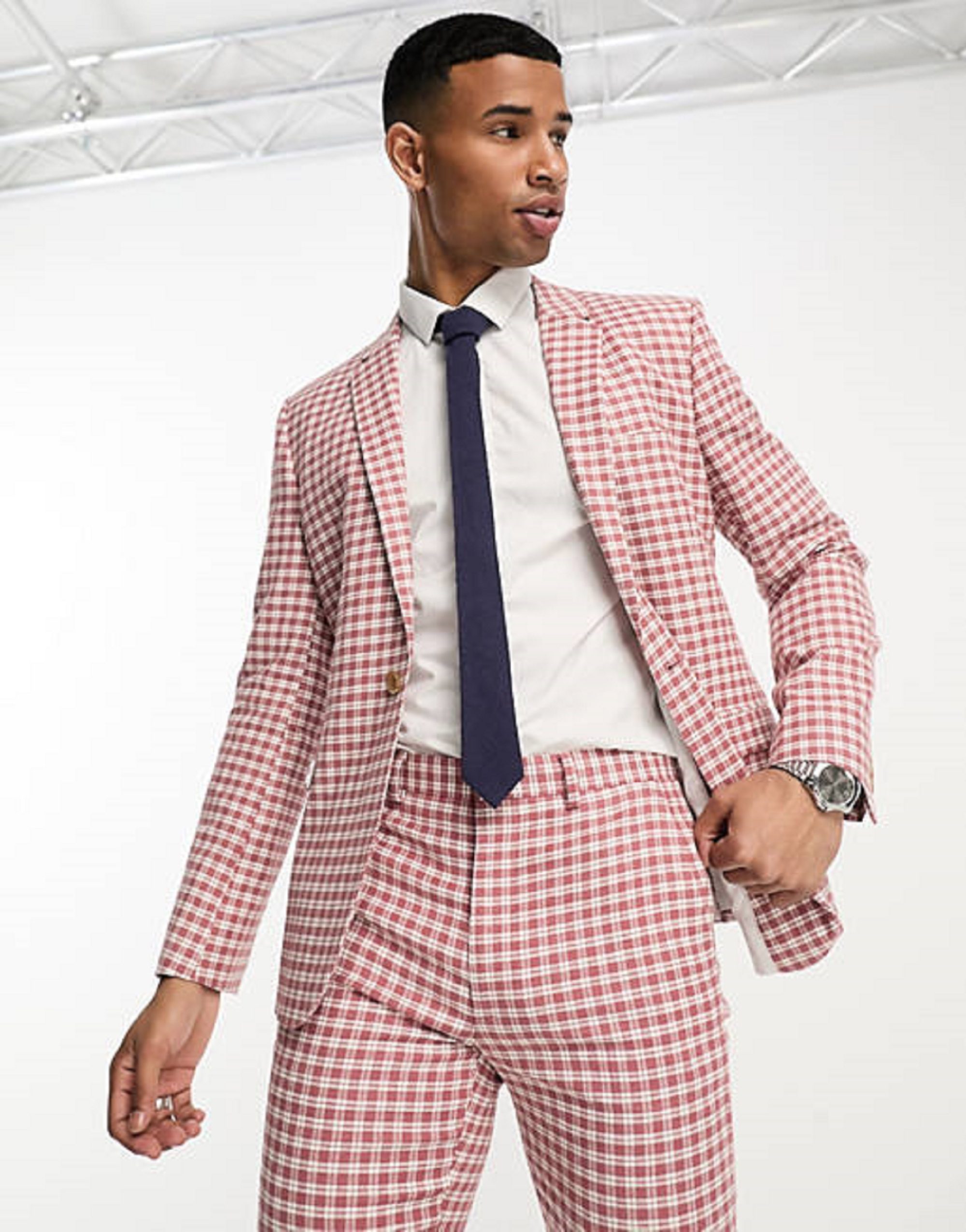 Man in pink patterned suit and blue tie