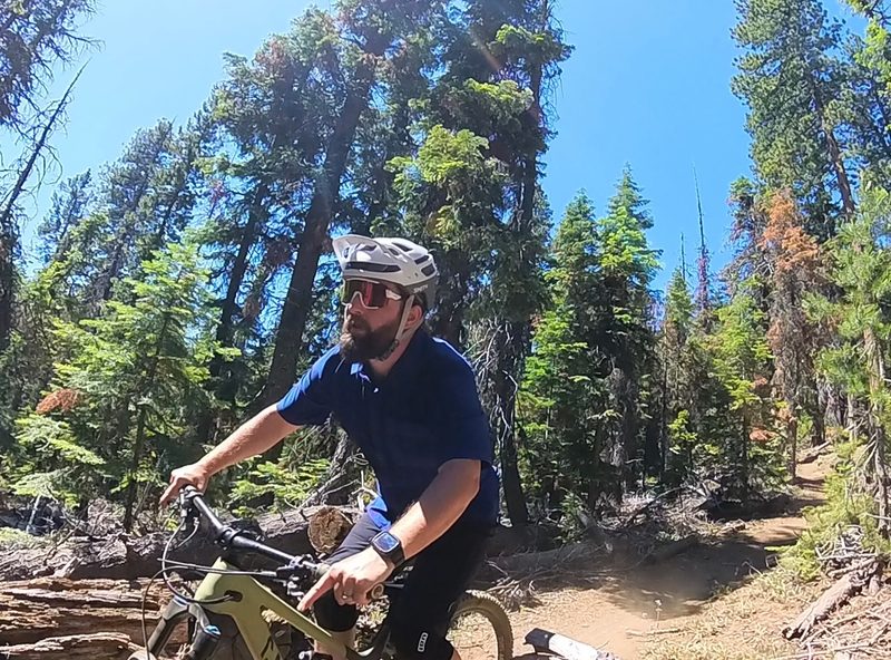 Mountain biking down a trail with the Smith Forefront 2 helmet and the Smith Wildcat sunglasses