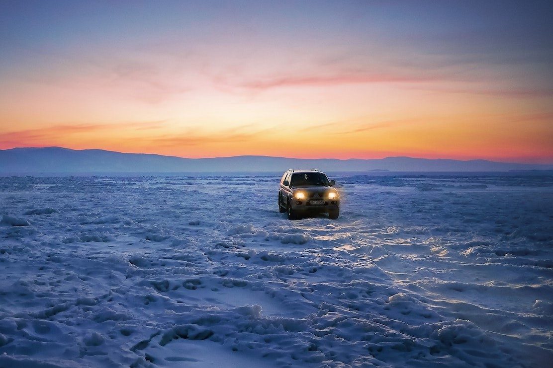 An SUV parked in a snowy remote location