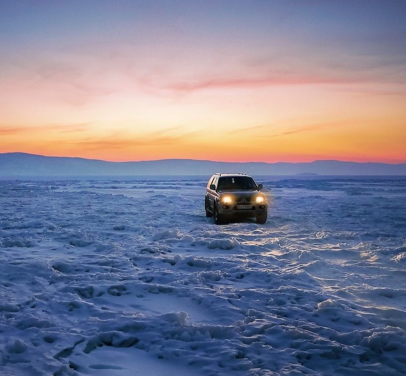 An SUV parked in a snowy remote location