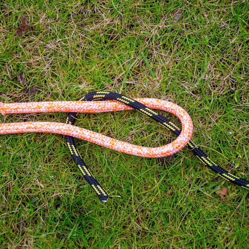 Two ropes in the process of being tied into a sheet bend.