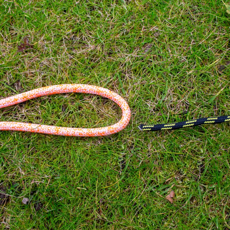 Two lengths of rope laid on the grass ready to tie a sheet bend.