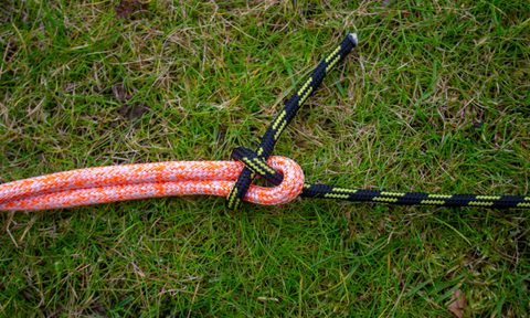 A sheet bend tied between a black rope and a red rope.