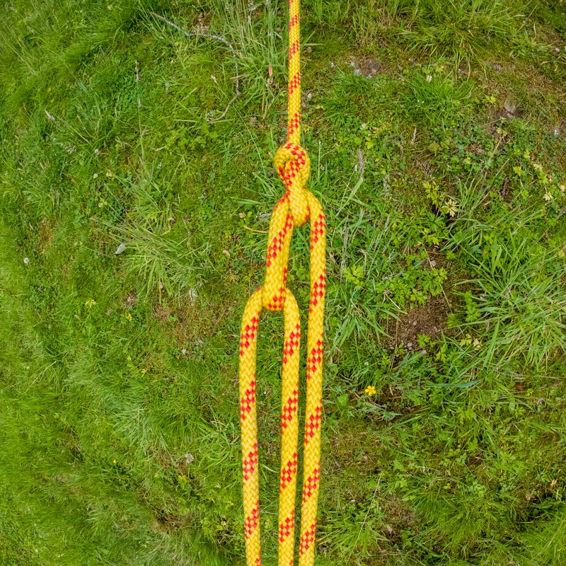 A trucker's hitch tied in yellow rope.