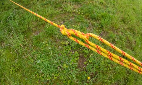 A trucker's hitch tied in yellow rope.