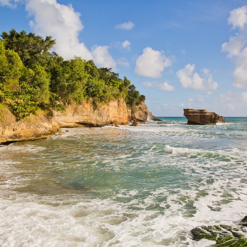 Waves lapping the small black sand beach at Anse Balenbouche in St. Lucia.