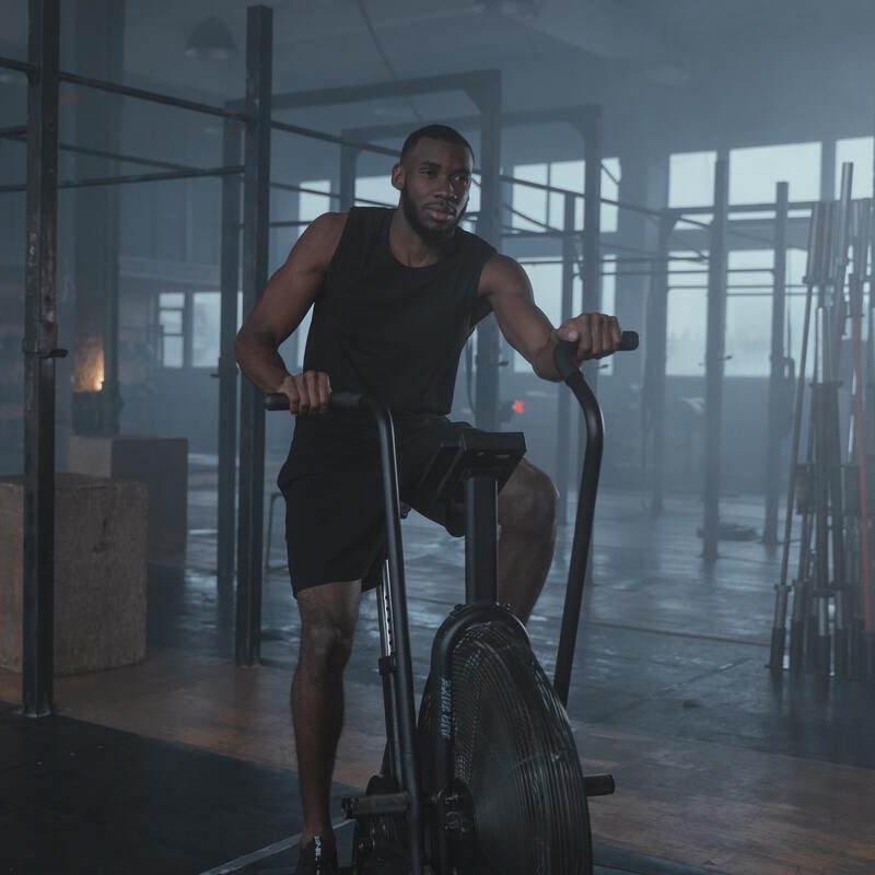 Man on stationary bike in the gym