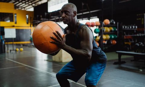 Man holding medicine ball.