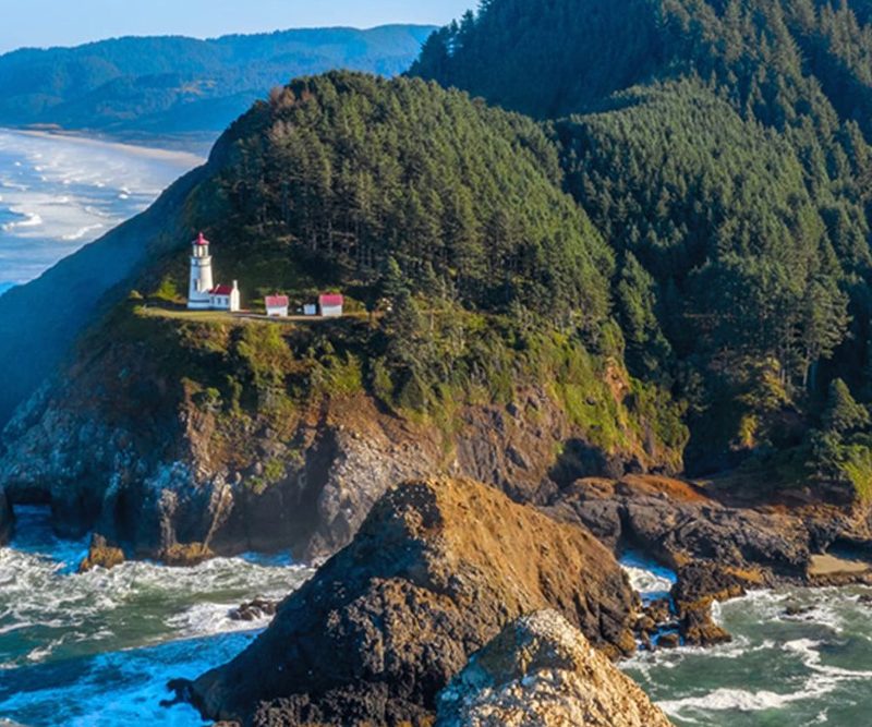 A wide aerial view of Heceta Lighthouse hotel in Yachats, Oregon