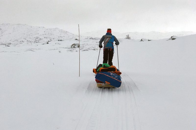 Man pulling a sled in Alaska's Iditarod Trail 1000 Invitational endurance race.